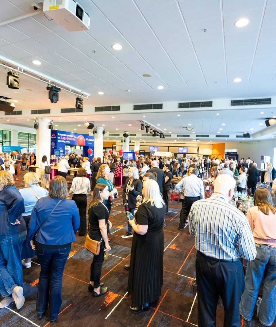 Delegates talking during a break at the 2026 conference