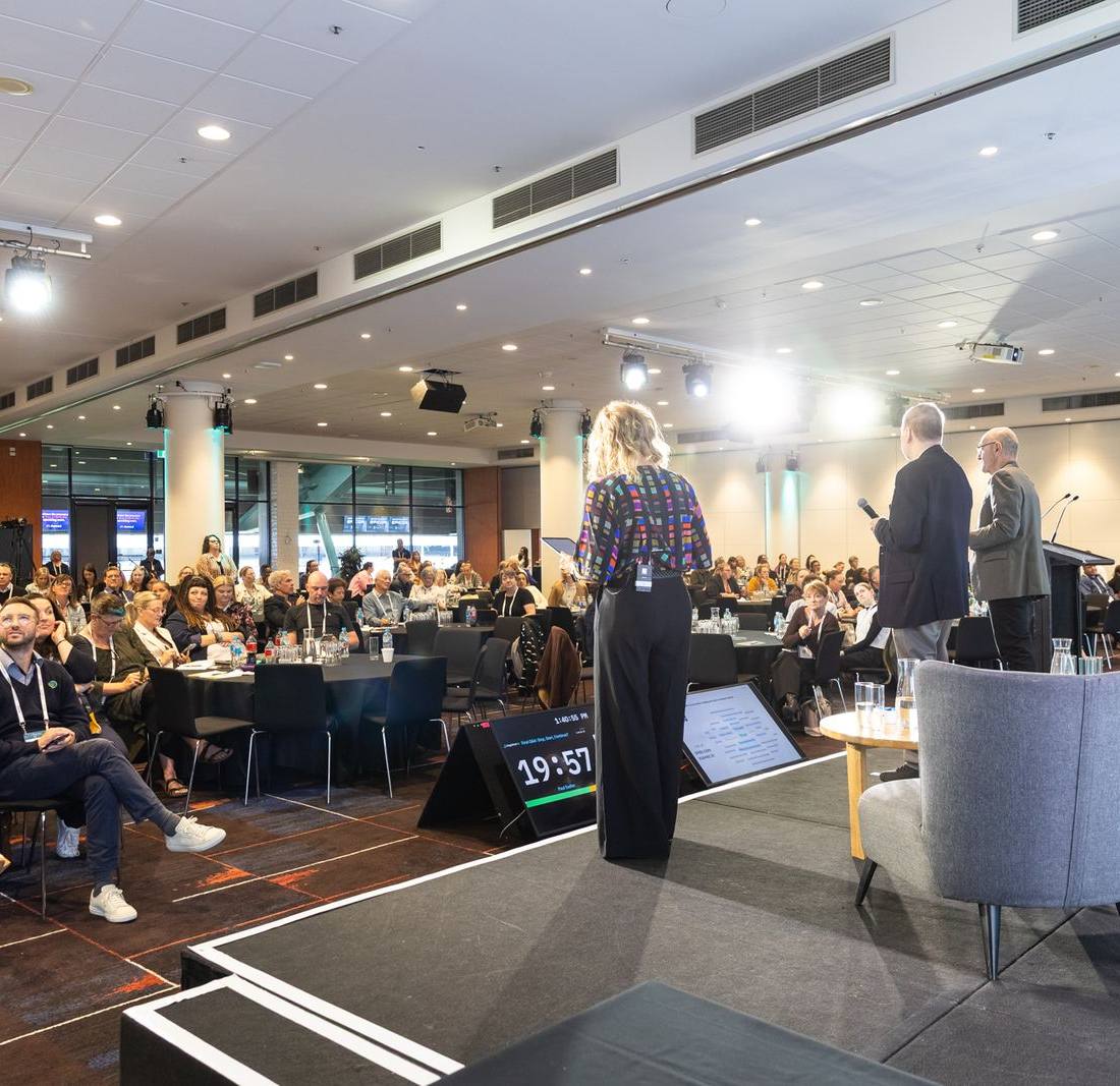 A panel session on stage at the 2026 conference